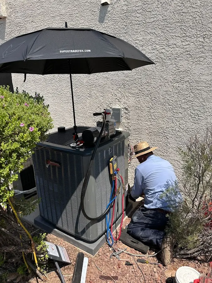 HVAC technician performing outdoor AC maintenance in Price